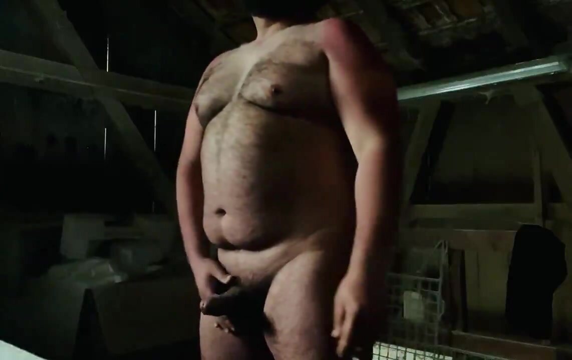 Farmer bear enjoys a quiet moment in the barn