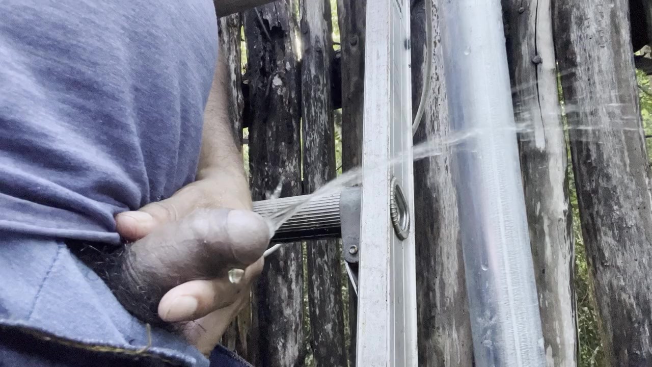 Gay Guy Pisses on Top of Ladder in Jungle