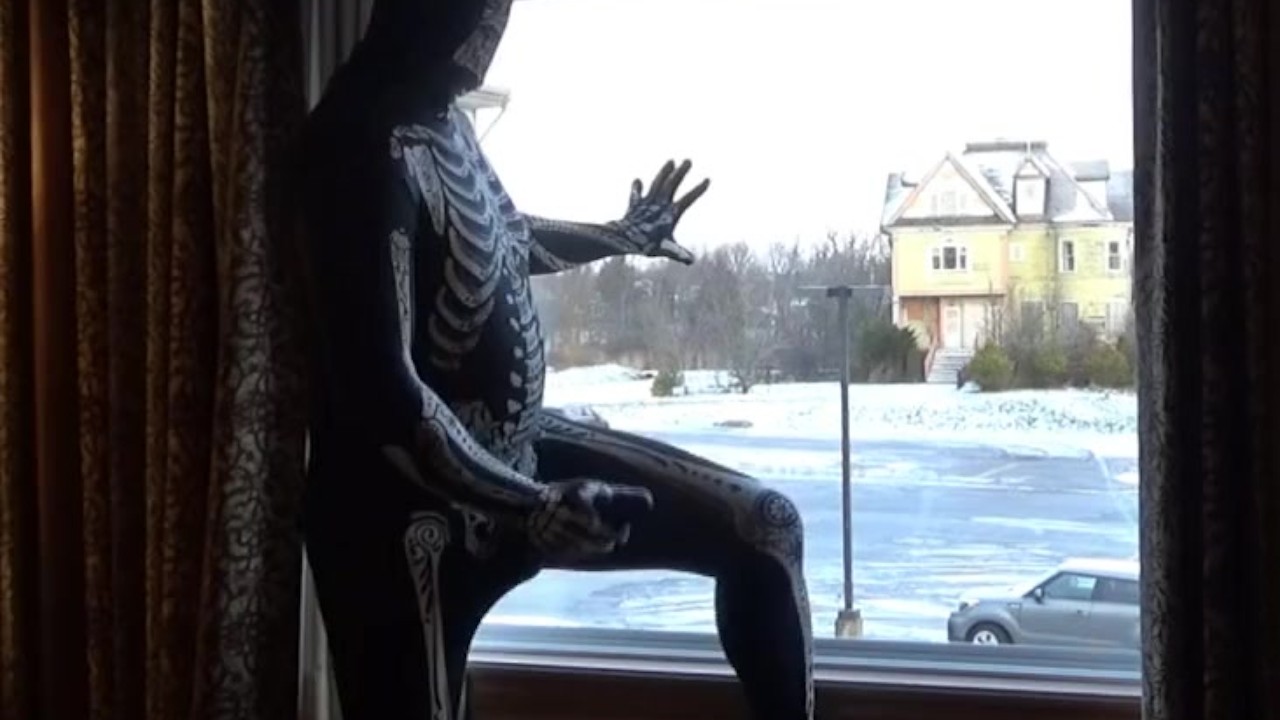 Dawn of the dead morphsuit in window cums into black rubber cock exten